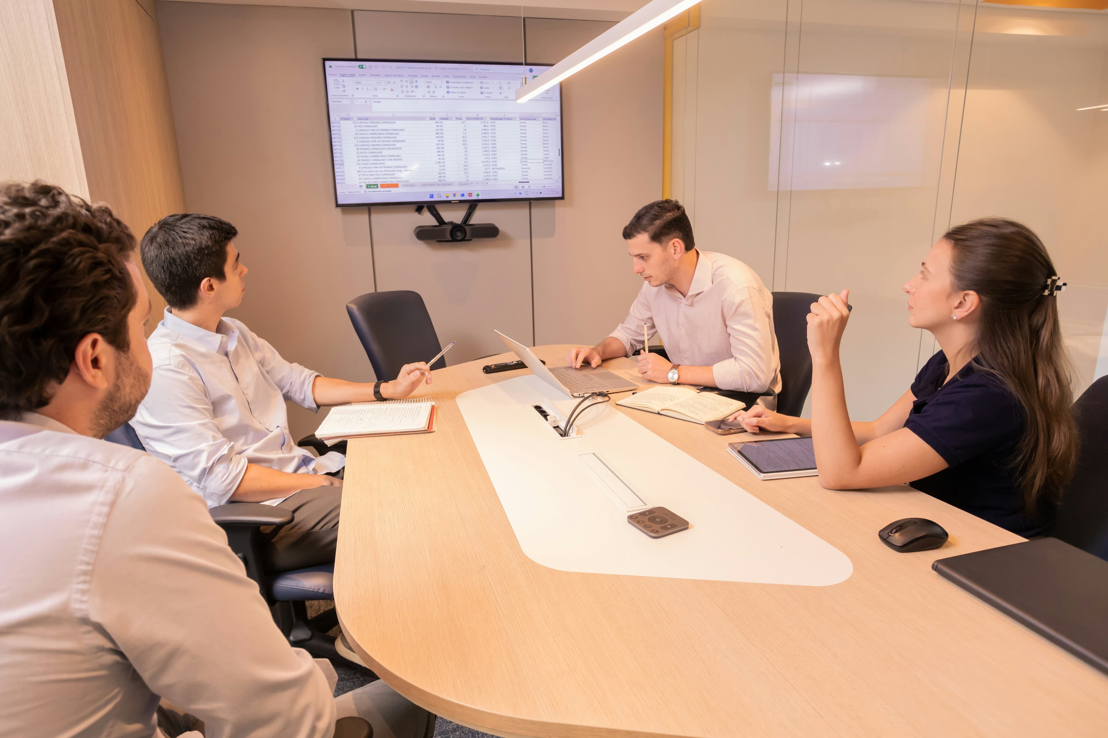 A legal team reviewing a governance document together around a meeting table