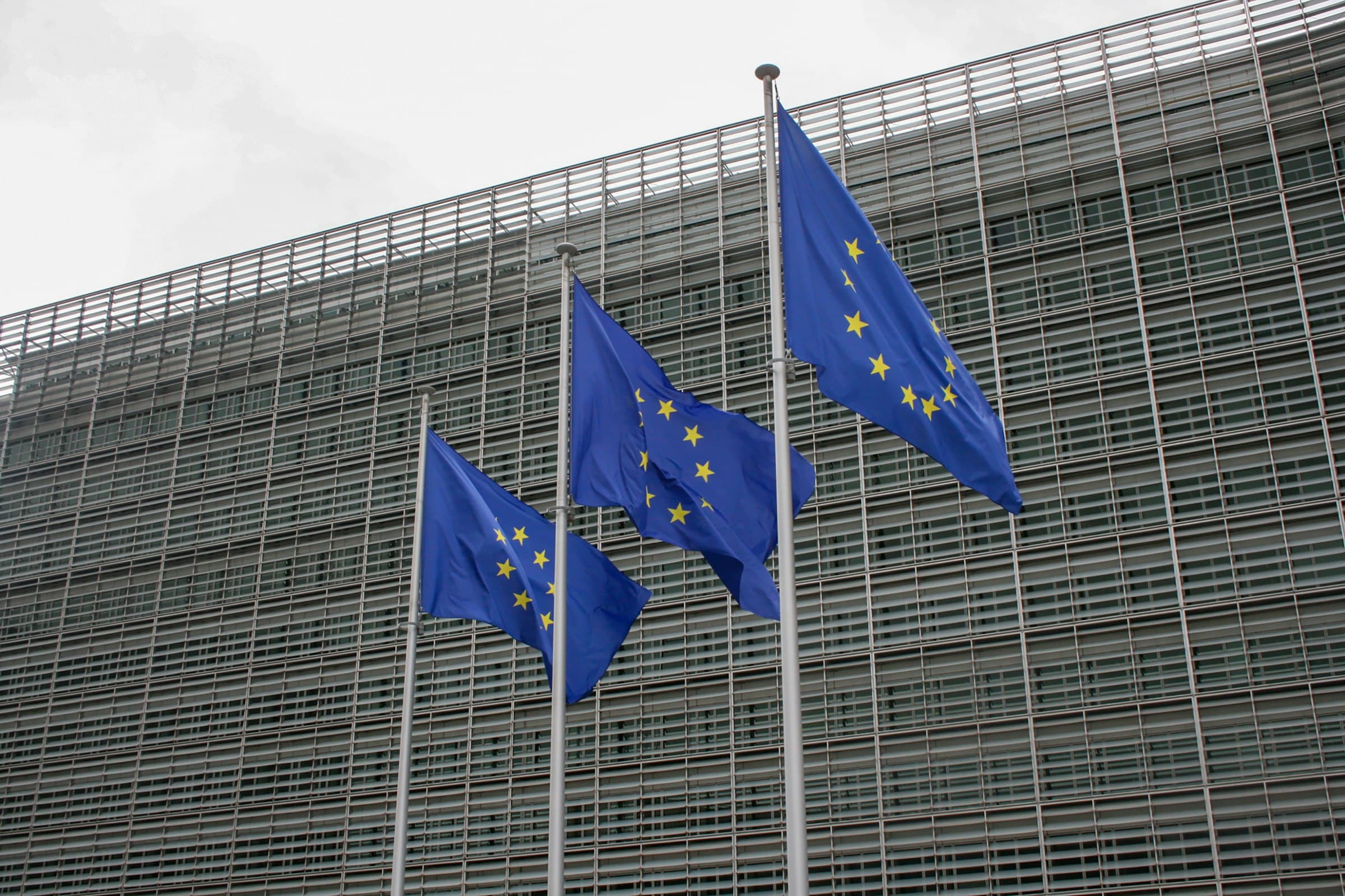 European Union flags flying in front of the European Commission's Berlaymont building in Brussels