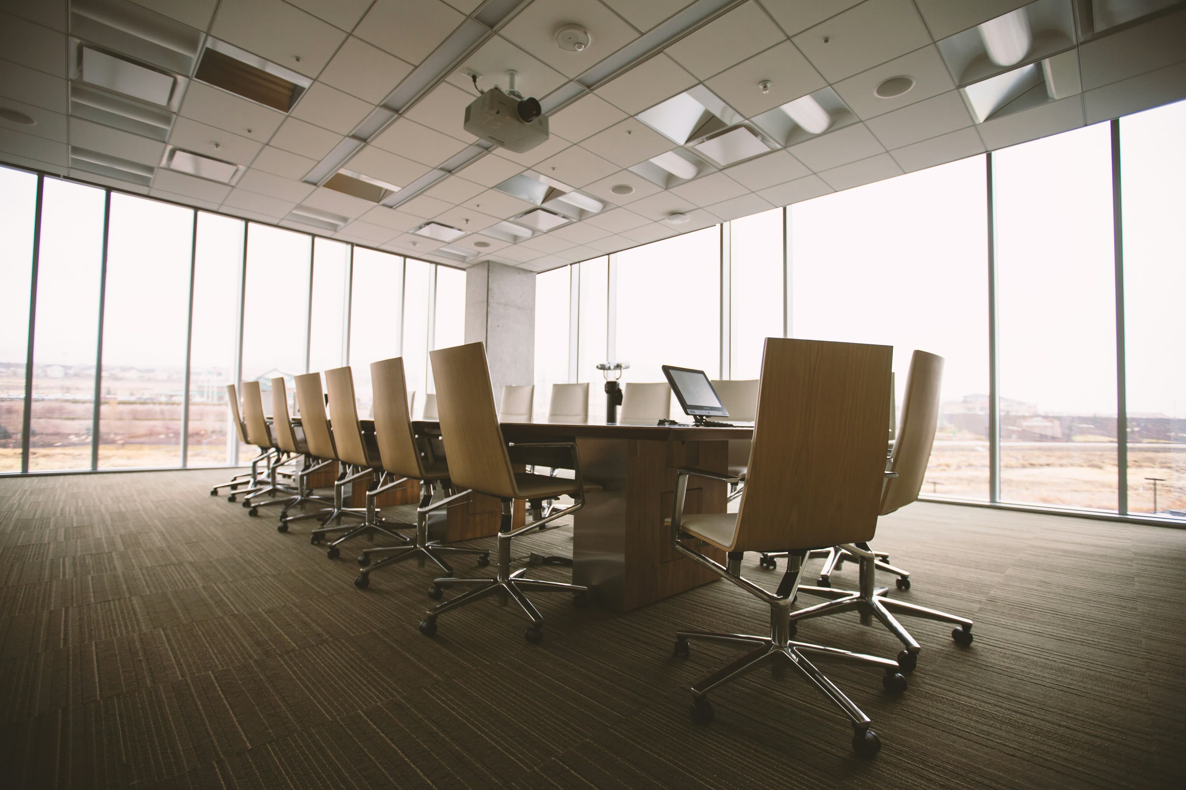 An empty modern boardroom overlooking the city